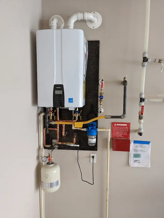 Professional plumber installing copper piping in a Sunrise home
